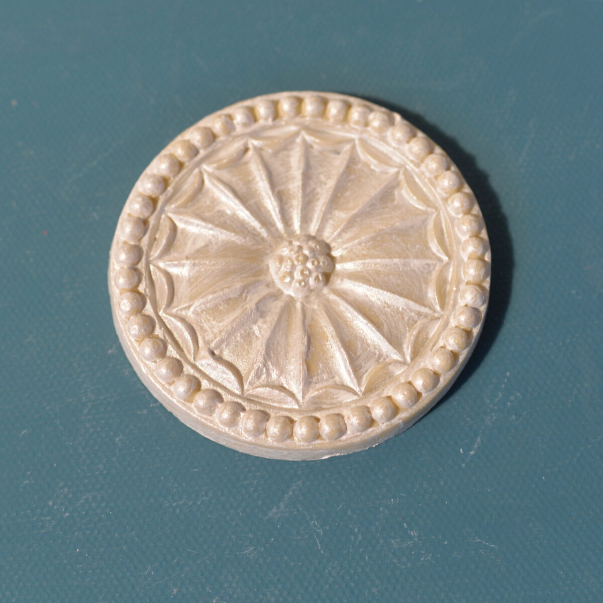 R35 Round Bead and Flower rosette, a circular Efex flexible moulding sunburst of pointed petals inside a beaded rim