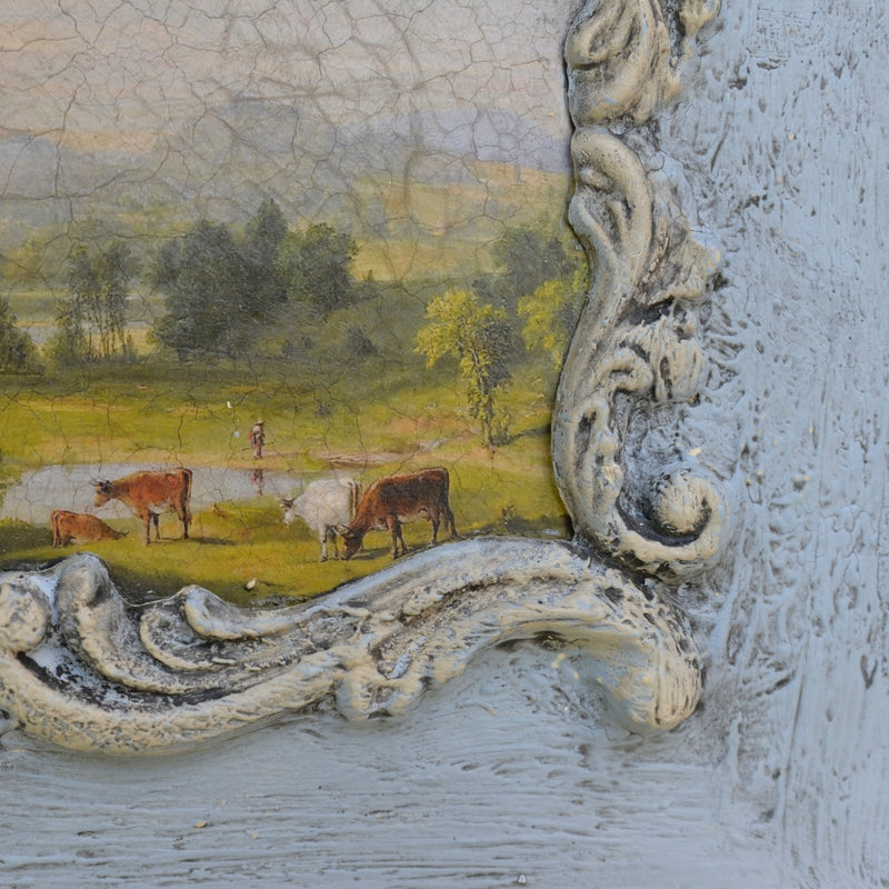 Corner of an F15 French Scroll Frame Efex flexible moulding in crackled white around a pastoral painting of cows by a pond