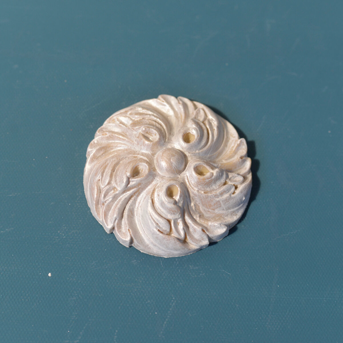 R10 Neo Classical Rosette, a round Efex flexible moulding rosette of swirling leaves around a domed centre, pearl finish