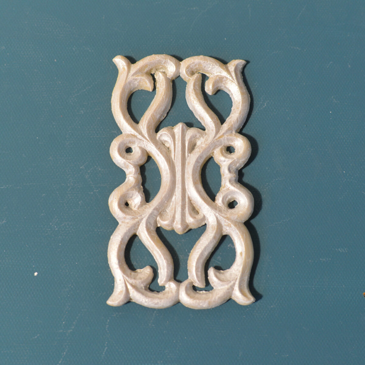 R18 Celtic Rosette, a rectangular open-work Efex flexible moulding panel of mirrored Celtic scrolls in a pearl finish