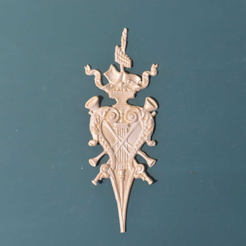 R47 Federal Style Rosette, a tall Efex flexible moulding trophy applique with a shield, crossed torches, plume and pointed base