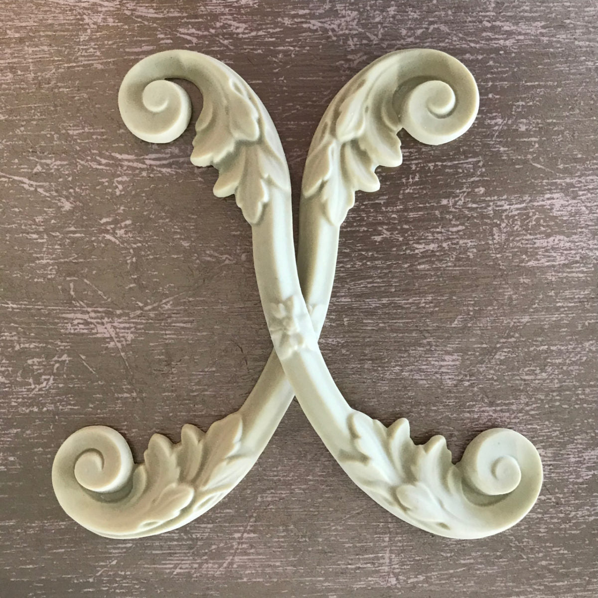 SC54 Architectural French Scrolls, a pair of Efex flexible moulding acanthus C-scrolls crossed in an X, painted sage green, 8.2 x 2.7 inches