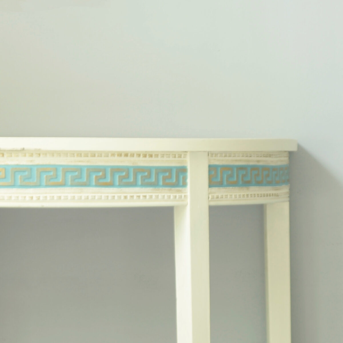 White console table with T33 Greek Key Trim Efex flexible moulding painted aqua on the apron, edged with fine bead mouldings